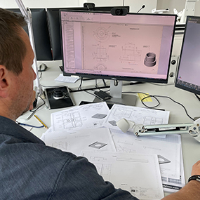 Engineer sits at his desk and works on product drawings