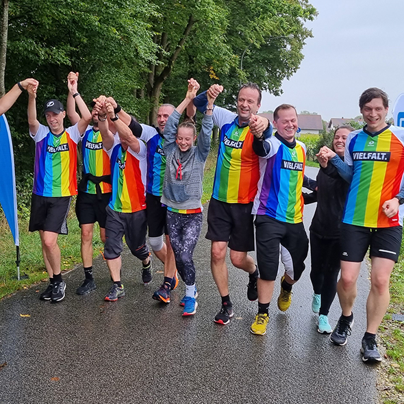 A diverse group of individuals crossing the finish line